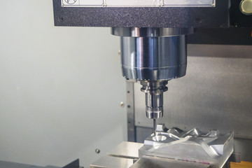 The CNC milling machine cutting the  automotive mold part with the solid ball endmill tool. Modern manufacturing process.