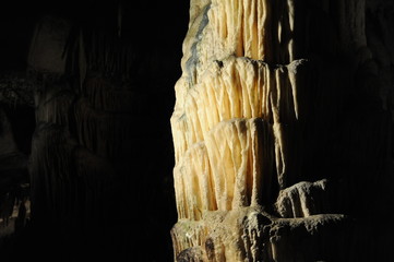 underground view of stalactites and stalagmites in natural halls in Postojna cave, Slovenia, Europe