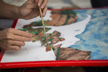 Hands working painting