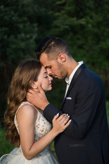 Elegant bride and groom posing together outdoors on a wedding day