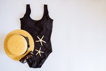 overhead view of beach clothing set. flat lay on white background. copy space