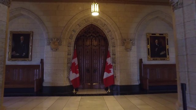 Camera dolly away from house of commons door in parliament 