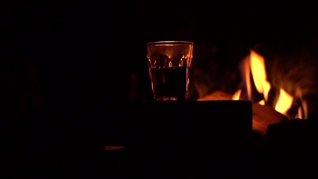 wine in glass on the background of fire