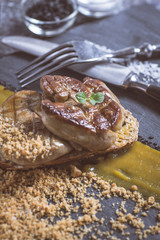 Fried Foie Gras with Mango Puree on Dark Stone Background. French Cuisine Concept.