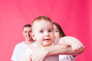 Cute baby looking at the camera, held by mother