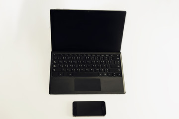 laptop and mobile phone on white background