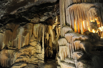 underground view of stalactites and stalagmites in natural halls in Postojna cave, Slovenia, Europe