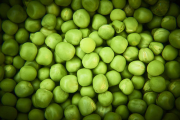 Fresh green peas background texture top view
