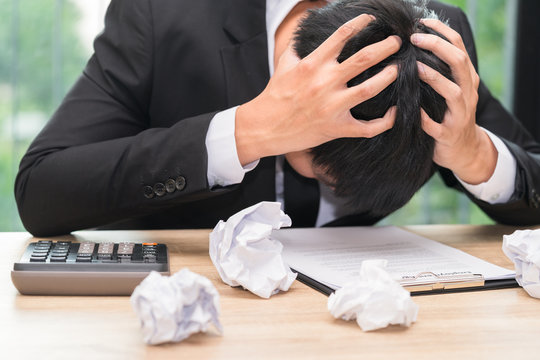 Stressed Businessman Make A Mistake With Chewed Paper - Migraine Or Headache Concept