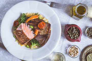 Salmon Fillet with Vegetables on Rustic White Plate