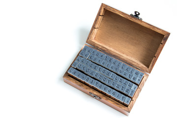 Wood box contain english alphabet and number rubber stamp on white background