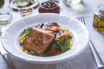 Salmon Fillet with Vegetables on Rustic White Plate