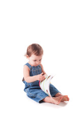 beautiful little baby with a book