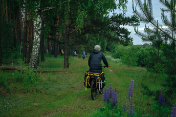 Bicyclist on the country road in village in the evening