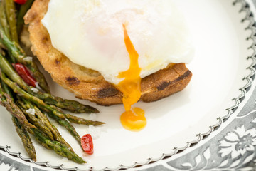 Freshly Poached Egg on Toast With Boiled Green Asparagus and Chili Peppers