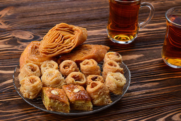 Turkish sweet baklava on plate with Turkish tea.