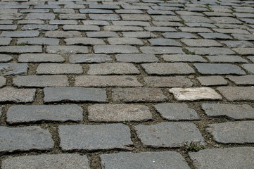 Paved old street gray surface closeup as urban background