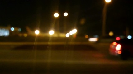 Defocused night time city driving plate shot on streets of Miami, city traffic background video - Powered by Adobe