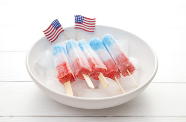 Fototapeta na wymiar Red White and Blue Popsicles in a Bowl of Ice to Keep them Cool for Serving to your BBQ Guests