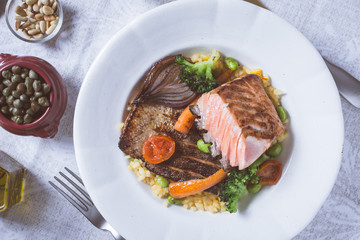 Salmon Fillet with Vegetables on Rustic White Plate