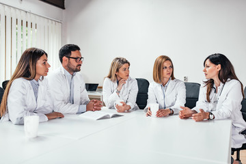Clinic, people, healthcare and medicine concept. Group of medical staff talking in a meeting.