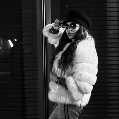 Waist up portrait of gorgeous female model wearing large round sunglasses, cap and stylish white...
