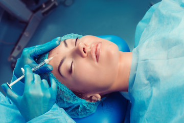 model having filler acid injection on the forehead