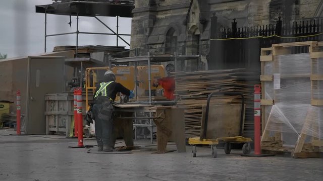 Rack focus to workers construction on parliament 