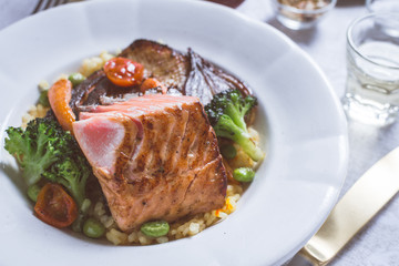 Salmon Fillet with Vegetables on Rustic White Plate
