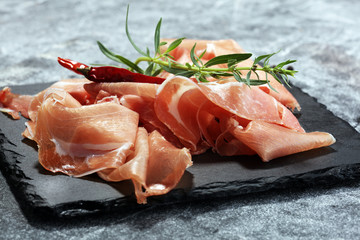Italian prosciutto crudo or jamon with parsley. Raw ham