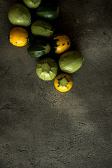 Yellow and Green Round Zucchini on Rustic Dark Background