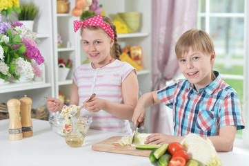 Cute brother and sister cooking together