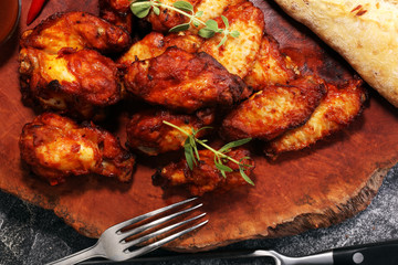 barbecue chicken wings close up on wooden tray