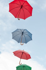 Many colorful umbrellas on the open sky