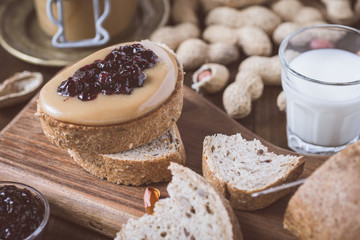 Fresh Peanut Butter and Jelly Sandwich on Old Rustic Wooden Cutting Board