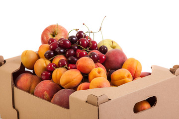 Close up of fresh and tasty organic fruits in cardboard box, isolated on white