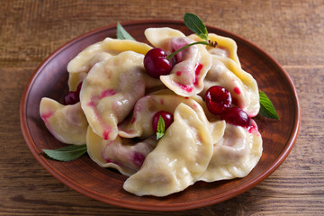 Dumplings, filled with cherries, berries. Pierogi, varenyky, vareniki, pyrohy - dumplings with filling, popular dish in many countries