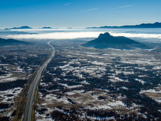Highway going into clouds with big hill beside it, highway to heaven, Croatia