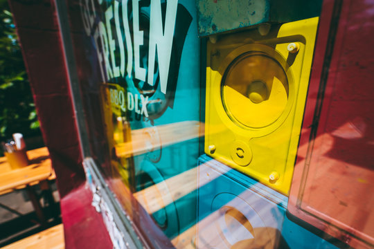 Close up of old retro multi colored sound speakers boxes behind the shop window vitrine on the city street