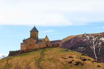 Fototapeta na wymiar Gergeti Trinity Church (Tsminda Sameba), Holy Trinity Church near the village of Gergeti in Caucasian mountains, Georgia