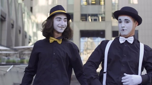 Two handsome mimes in hats