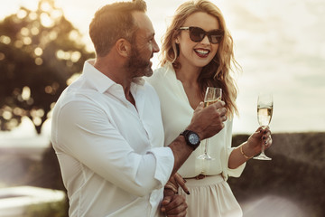 Smiling couple enjoying a glass of wine