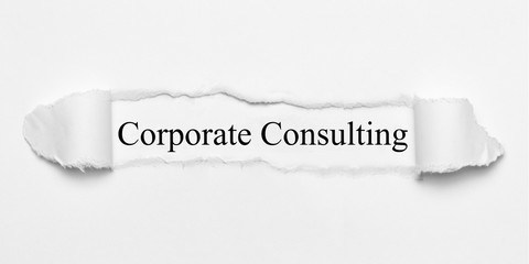 Corporate Consulting on white torn paper