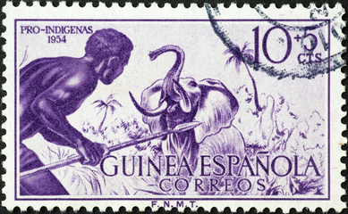 African native hunter and elephant on vintage stamp
