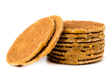 Stack of Dutch wafers with condensed milk on a white background.