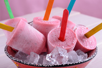 Colorful homemade ice cream from berries with color sticks