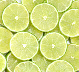 Obraz na płótnie Canvas Green background with citrus-fruit of lime slices