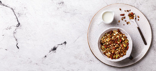 Granola cinnamon with milk on a marble Background. Breakfast  Healthy Food. Diet Nutrition Concept.  Top View. Flat Lay.Copy space for Text. Banner