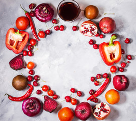 Raw red organic vegetables with fresh ingredients for healthily cooking on concrete background, top view. Vegan or diet food concept