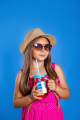 Pretty little girl with hat and sunglasses with summer lemonade. Summer vacation and travel concept